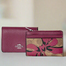 Load image into Gallery viewer, A Coach card holder mini wallet with a red bow signature canvas design, displayed alongside its compact, folded version.