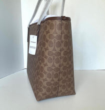 Load image into Gallery viewer, Coach tote bag with a visible tag on a white background