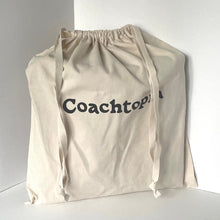 Load image into Gallery viewer, Beige drawstring bag with 'Coachtots' branding on a white background