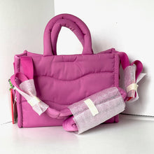 Load image into Gallery viewer, Pink handbag with decorative ribbons on a white background