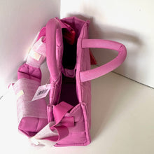 Load image into Gallery viewer, Pink baby carrier on a white surface with a white background