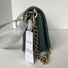 Load image into Gallery viewer, Green Coach handbag with gold chain strap on a white background