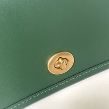 Load image into Gallery viewer, Green leather bag with a gold clasp on a white background