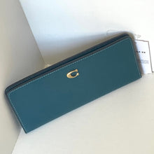 Load image into Gallery viewer, Teal wallet with gold emblem on a white surface