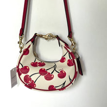 Load image into Gallery viewer, Coach handbag with cherry design on a white background