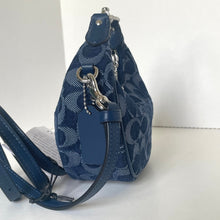 Load image into Gallery viewer, Blue patterned handbag with a strap on a white background