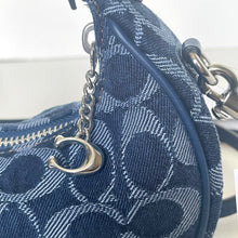 Load image into Gallery viewer, Blue patterned handbag with a silver chain and clasp on a blurred background