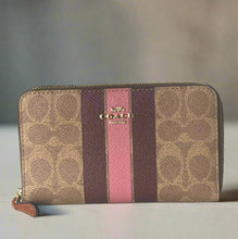 Load image into Gallery viewer, Coach wallet with brown, purple, and pink stripes on a white background