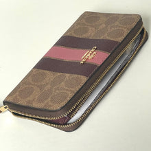 Load image into Gallery viewer, Brown patterned wallet with gold zipper on a light beige background