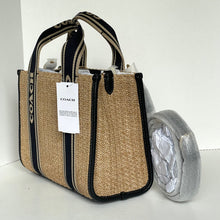 Load image into Gallery viewer, Coach handbag with a tag on a white background