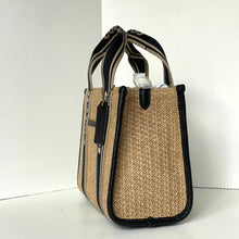 Load image into Gallery viewer, Beige handbag with black accents on a white background