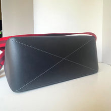 Load image into Gallery viewer, Black handbag with red strap on a white surface