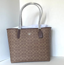 Load image into Gallery viewer, Coach tote bag with a white interior on a white background