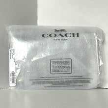 Load image into Gallery viewer, Coach New York pouch in clear packaging on a gray background