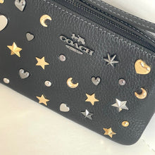 Load image into Gallery viewer, Coach wallet with star, moon, and heart embellishments on a white background