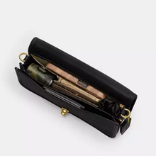 Load image into Gallery viewer, Black handbag with gold accents on a white background