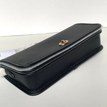 Load image into Gallery viewer, Black leather clutch bag with gold clasp on a light gray background