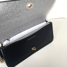 Load image into Gallery viewer, Black handbag with gold hardware on a white background