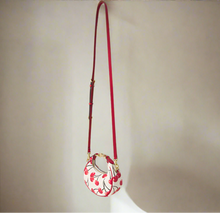 Load image into Gallery viewer, Small handbag with floral design and red strap on a white background