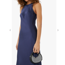 Load image into Gallery viewer, Woman wearing a blue dress holding a black coach crystal handbag with a white background