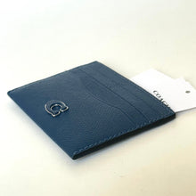 Load image into Gallery viewer, Blue leather wallet with a brand tag on a light beige background