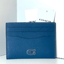 Load image into Gallery viewer, Blue cardholder with Coach logo on a white background