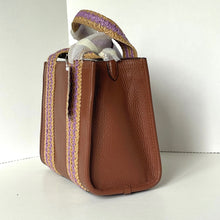 Load image into Gallery viewer, Brown leather handbag with purple and gold accents on a white background