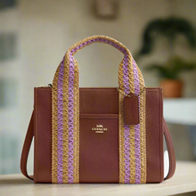 Load image into Gallery viewer, Brown handbag with purple and yellow striped handles on a white background