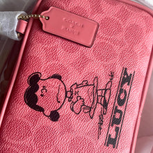 Load image into Gallery viewer, Pink Coach bag with a cartoon design and 'Lucy' text, featuring a gold tag.