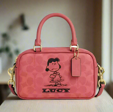 Load image into Gallery viewer, Pink handbag with a character design and 'Lucy' text on a white background