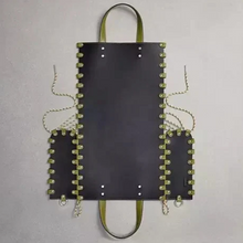 Load image into Gallery viewer, Black leather bag with green accents on a gray background