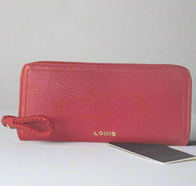 Load image into Gallery viewer, A red leather Lodis Isabella RFID slim zip wallet with gold tone trim, displayed on a wooden surface next to a smartphone.
