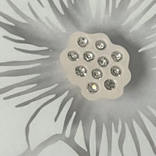 Load image into Gallery viewer, Decorative flower with a central gemstone on a gray background