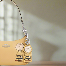 Load image into Gallery viewer, CoachxPeanuts2025CharlieBrownLeatherBagCharmKeychainCBG59Anniversary_2