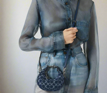 Load image into Gallery viewer, Person wearing a denim outfit with a matching handbag on a white background