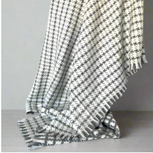 Load image into Gallery viewer, Gray and white patterned blanket with fringe on a light gray background