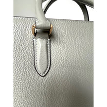 Load image into Gallery viewer, Close-up of a light gray handbag with a gold clasp on a white background
