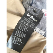 Load image into Gallery viewer, Barbour jacket label on a beige garment with a white background