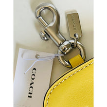 Load image into Gallery viewer, Coach keychain with a yellow tag on a white background
