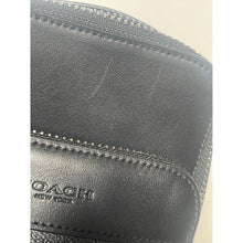 Load image into Gallery viewer, Close-up of a black leather Coach wallet with visible branding.