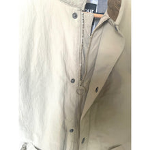 Load image into Gallery viewer, Close-up of a beige vest with a zipper on a white background