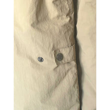Load image into Gallery viewer, Close-up of a beige jacket with a button on a white background