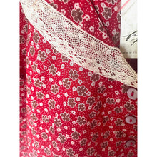 Load image into Gallery viewer, Red fabric with floral pattern and lace trim on a white background