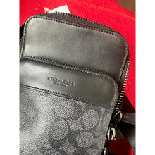 Load image into Gallery viewer, Coach wallet with signature pattern on a red background