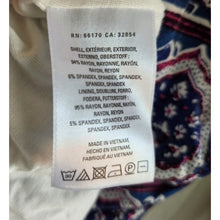 Load image into Gallery viewer, Clothing label with fabric composition and care instructions on a garment.