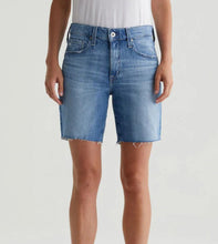 Load image into Gallery viewer, Blue denim shorts worn by a person on a white background