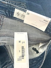 Load image into Gallery viewer, Close-up of folded blue denim jeans showing the inner waistband, size tag, and product labels. The labels indicate Aquaso, Los Angeles, size 29, and the wash/style text 'High-Rise Fade'.