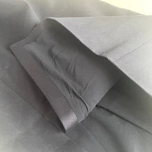 Load image into Gallery viewer, Folded black fabric on a gray surface