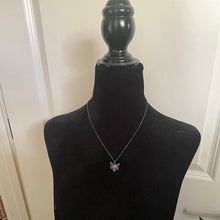 Load image into Gallery viewer, Necklace with a starfish pendant on a black mannequin against a white wall.