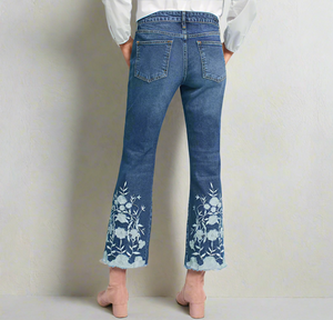 Flared jeans with floral embroidery on a light blue background